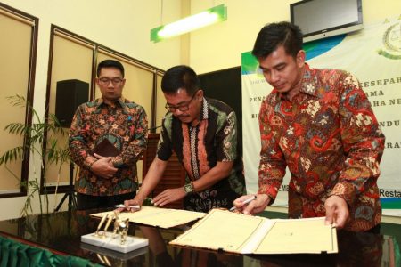 Kepala Kejati Jabar Setia Untung Arimuladi bersama Dirut PDAM Tirtawening Sonny Salimi disaksikan Wali Kota Bandung Ridwan Kamil menandatangani nota kesepahaman, Kamis (3/11) malam. (diskominfo for jabartoday)